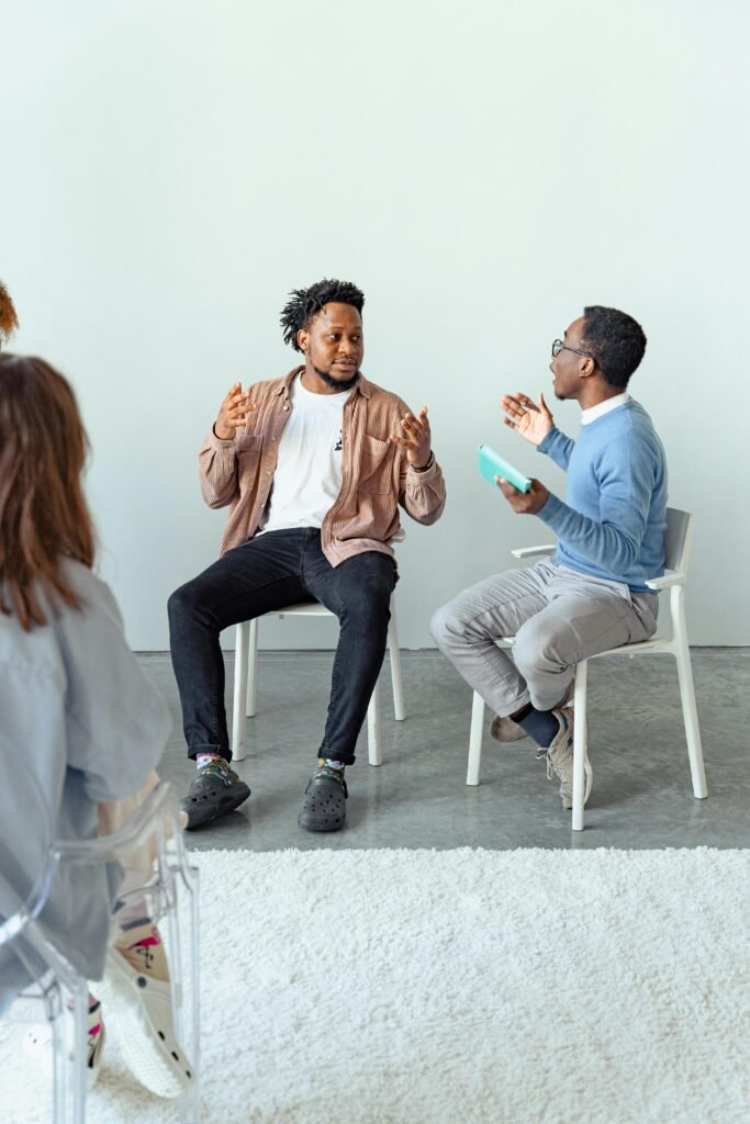 pexels-photo-7579180-7579180 Therapist and client in a dynamic discussion during a therapy session with a focus on mental health.